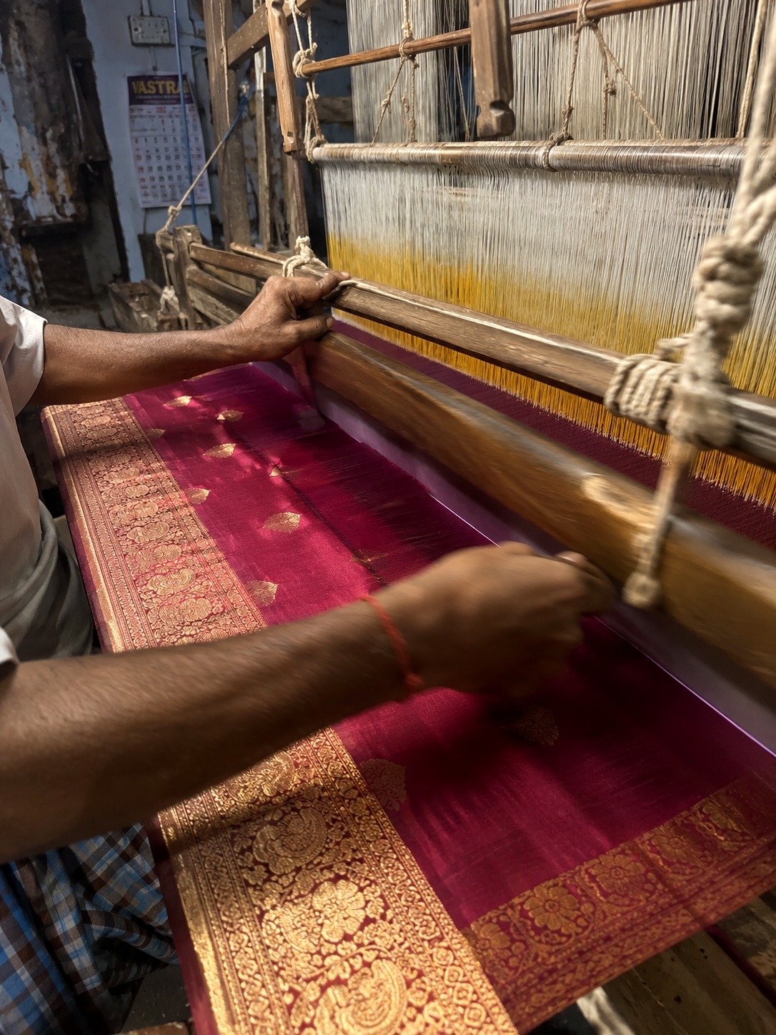 A Banarasi silk weaver working the handloom in Varanasi